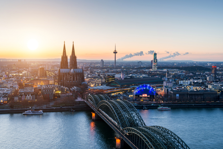 Abendlicher Blick von der Aussichtsplattform KölnTriangle über den Rhein auf die Hohenzollernbrücke, den Kölner Dom, den Musical Dome und den links daneben liegenden Köln Hauptbahnhof