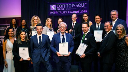 Eine Gruppe von Hoteldirektoren mit einer Urkunde in der Hand