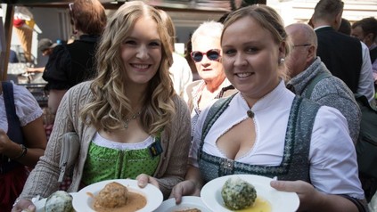 Zwei Frauen in Dirndl halten Essen