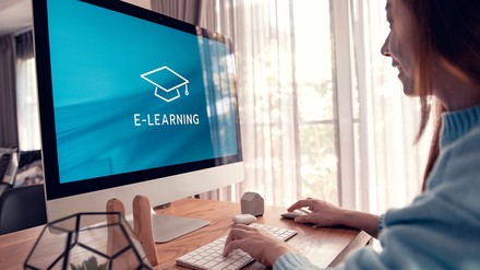 Junges Mädchen sitzt vor einem PC und nutzt ein E-Learning-Angebot