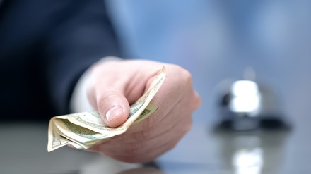 Ein Hotelier mit Geld in der Hand