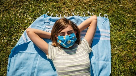 Eine Urlauberin mit Mundschutzmaske