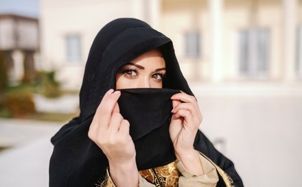 Muslimische Frau verdeckt ihr Gesicht