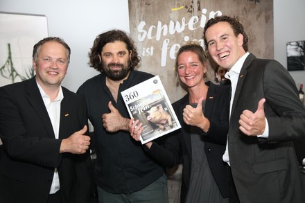 Konstantin Filippou und drei andere Würdenträger präsentieren ein Magazin auf dem Schwein ist fein steht