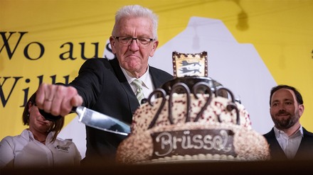 Winfried Kretschmann (Bündnis 90/Die Grünen), Ministerpräsident von Baden-Württemberg, schneidet beim Neujahrsempfang der baden-württembergischen Landesregierung in der Landesvertretung Baden-Württembergs in Brüssel eine große Schwarzwälder Kirschtorte an. (Foto: © picture alliance/dpa | Marijan Murat)
Winfried Kretschmann beim anschneiden der Riesentorte auf dem Neujahrsempfang in Brüssel.