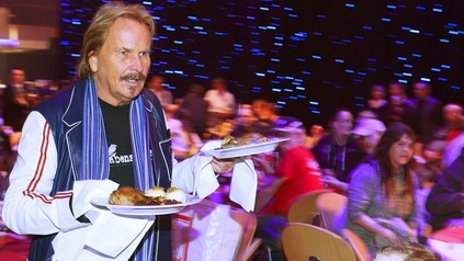 Frank Zander mit Teller voller Gänsebraten in den Händen