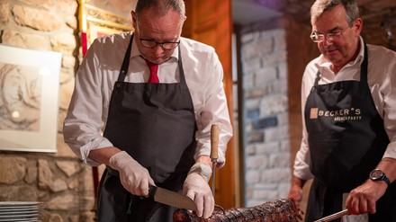 Christian Keiser (l) und Arno Milde vom Spießbratenclub Trier schneiden den Spießbraten in Portionen für die Clubmitglieder. (Foto: © picture alliance/dpa | Harald Tittel) Christian Keiser (l) und Arno Milde vom Spießbratenclub Trier schneiden den Spießbraten in Portionen für die Clubmitglieder.