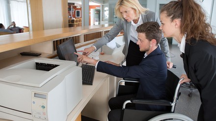 Mann im Rollstuhl an der Rezeption im Hotel