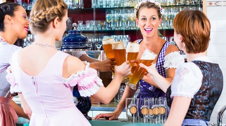 Wirtin in bayerischer Kneipe mit Gästen