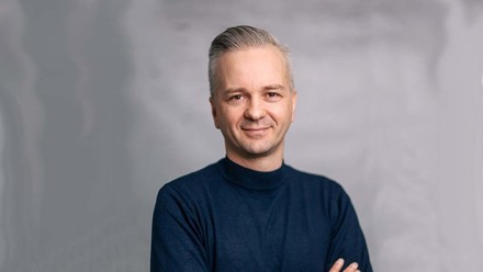 Recruiting-Experte Steve Heinecke mit verschränkten Armen vor grauem Hintergrund