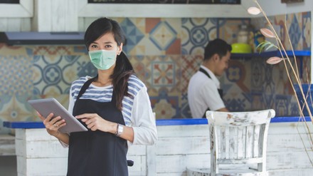 waitress using digital tablet and wear face masks