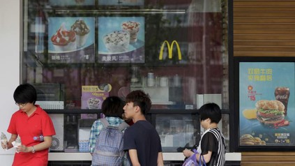 Asiaten stehen vor Mc Donald's