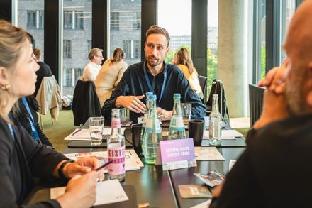 Ein Mentor spricht in einer kleinen Gesprächsrunde mit Teilnehmern bei „Meet the Best“ 2025.