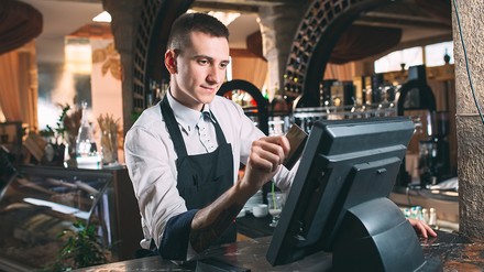 Ein Gastronom an einer Kasse