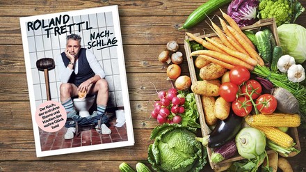 Buchcover „Nachschlag“ von Roland Trettl liegt auf einem Tisch mit verschiedenen Gemüsesorten