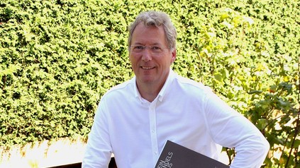 Philippe Schneider mit einem Weinkatalog in der Hand