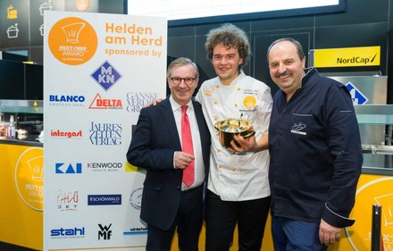 Marianus von Hörsten, Chef de Partie im Tabula Rasa in Hamburg, hat sich erfolgreich zum Next Chef 2018 gekocht.(Foto: Ulrich Perrey)
Marianus von Hörsten mit Johann Lafer und einem weiteren Würdenträger hält einen goldenen Topf in der Hand