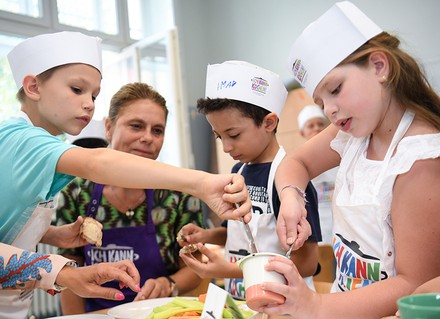 Das Hygiene-Merkblatt der Sarah Wiener Stiftung ist mit den Behörden der amtlichen Lebensmittelüberwachung aller deutschen Bundesländer abgestimmt. (© picture alliance/Arne Dedert/dpa)
Sarah Wiener mit Kinderköchen