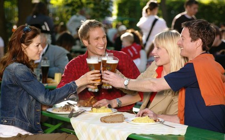 FReunde im Biergarten stoßen an