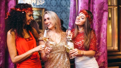 3 Frauen auf einem Ball mit einem Sektglas