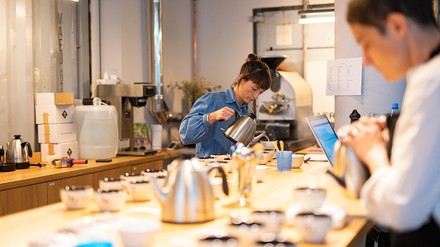 Wettbewerb „Cup of Excellence“; Frauen gießen Kaffee in die Tassen.