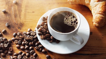 Cup of hot coffee on wooden table